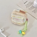 Close-up of woven earphone case with colorful stripes and beaded green lanyard strap - Creamy White