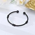Detail of black twisted wire stainless steel cuff bracelet with spherical beads - Style 2 / Black