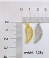Macro shot of gold and silver wing pendants with cubic zirconia and 1.28g weight detail - Style G-Gold Wing Pendant