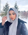 Elegant grey pearl chiffon hijab scarf shown on a model against a snowy outdoor background - Silver