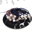 Détail d'élastiques à perles avec billes dorées sur un plateau en marbre noir - Multicolore