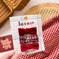 Close-up of three red fabric bow hair clips for girls set on a checkered card - Red Velvet & Fabric Bow Set 3Pcs