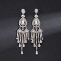 Detailed macro view of long silver tassel earrings with sparkling rhinestone crystals - Water Drop Style / Silver