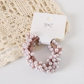 Detail of a handmade pink pearl beaded hair tie on an elegant lace and wood background - Card Packaging / Pink