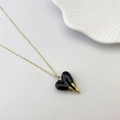 Gothic black heart pendant with golden claw decor on a delicate gold chain necklace - Black