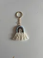 Detail of handmade bohemian rainbow keychain with blue and beige yarn and white fringe - Blue Brown