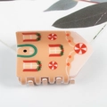 Pince à cheveux maison en pain d'épices orange avec fenêtres blanches et détails sucre - Maison en Pain d'Épice Orange et Menthe