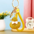 Close-up of a sparkling rhinestone duck keychain with gold hardware and a yellow woven strap - Braided Yellow Rhinestone Duck