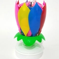 Lotus shaped musical birthday candle in pink yellow blue and red with a green base - Layered Style / Colorful