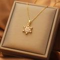 Elegant gold snowflake pendant necklace with cubic zirconia on champagne silk background - 75#XL2159-3