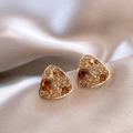Macro shot of triangle stud earrings with amber crystals on silk fabric - Gold Brown