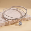 Close-up of silver double-layered choker with cubic zirconia and pear-shaped pendant - Neck Ring - Silver