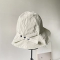 Detail of beige nylon sun hat with cross strap and three black decorative buttons - Beige