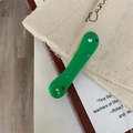 Detail of green acrylic hair clip with colorful rhinestones on a vintage book - Green Rhinestone Hair Clip