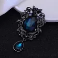 Vintage brooch with oval and teardrop deep blue gemstones set in black filigree frame - Gun Black Peacock Blue Gem
