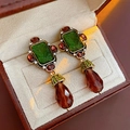 Detail of vintage gold earrings with green gems, red stones and brown crystal drops - Vintage Gold Coffee Green Relief Portrait Silver Earring Post Dangle Earrings