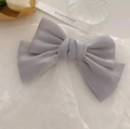 Morandi grey satin bow hair clip with elegant layered silk texture in a chic setup - Gray