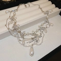 Close-up of multilayer silver necklace with teardrop pearls and sparkling diamond bows - Multi-layer Bow Knot Pearl Necklace - Silver - White