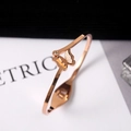 Detail of rose gold butterfly open bangle with matte texture and sparkling crystal - Rose Gold