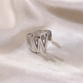 Silver letter W open ring in minimalist style on a champagne silk background - Letter W / Silver