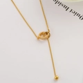 Elegant gold double ring necklace with zircon pavé detail on a minimalist white background - Zirconia Double Ring Tassel