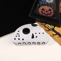 Macro detail of Halloween hockey mask hair claw clip on dark festive background - Black and White Mask Face
