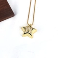 Detail of a gold star pendant with letter W inlay on a textured background - Letter W