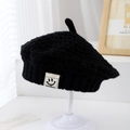 Close-up of black knit beret for kids featuring a smiley face patch and top pointed detail - 1-3 Years / Black