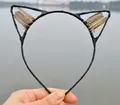 Cat ear headband with brown crystal clusters and black wire frame held by hand - No.31 Smoky Brown