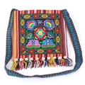 Detail of ethnic embroidery pattern with colorful tassels and wooden beads on canvas bag - Red Ruyi