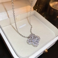 Close-up of a silver four-leaf clover pendant with zircon in a white jewelry box - Clover Pendant Necklace (Silver)