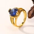 Close-up of a gold-plated titanium ring with a faceted blue zircon and split shank band - Gold Plated Blue Zirconia