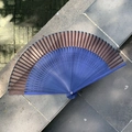 Classic folding fan with dark blue bamboo frame and brown fabric, elegant oriental style - Hollow Crescent Blue Coffee