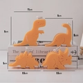 Set of four orange dinosaur-shaped scented candles including T-Rex and Stegosaurus - Orange Dinosaur - Set of 4