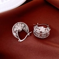 Macro shot of silver hollow-out flower hoop earrings on deep burgundy velvet background - Silver Hollow Flower Hoop Earrings / Silver