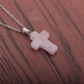 Close-up of natural rose quartz cross pendant on a thin silver stainless steel chain - Rose Quartz Cross