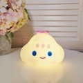 Cute cloud shaped night light in warm yellow with blue eyes on a white desk - Purple Cloud