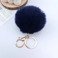 Close-up of deep blue plush pompom keychain with golden lobster clasp and metal ring - Navy Blue