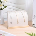 Detail of velvet necklace display stand with solid wood base and cream fabric finish - Flannelette / Beige