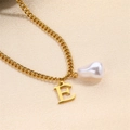 Elegant golden letter E necklace featuring a white baroque pearl on a fine metal chain - Letter E Necklace