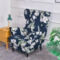 Navy blue wingback chair cover with white floral print on gray rug in a cozy room - Garden Style Blue
