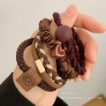 5-piece coffee brown elastic hair ties with charms shown on wrist for little girls - Milk Coffee