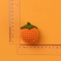 Handmade crochet orange keychain charm with green leaf detail, 5cm diameter size view - Light Orange Persimmon Doll