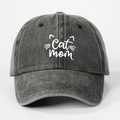 Front view of washed dark grey denim baseball cap with white Cat Mom embroidery - Black