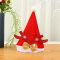 Red velvet Christmas hat with glitter antlers and gold bow on wooden tabletop - Kids Red Reindeer Antlers