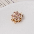Detailed macro of golden rotating flower clasp with micro-set cubic zirconia and pink stones - 12# 14K Gold Double Row (15*20mm)