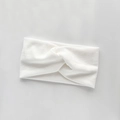 White knitted twisted headband for kids made of soft ribbed stretch fabric - White