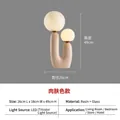 Modern U-shaped art table lamp with dual glass globes and resin body in flesh pink - Flesh/Nude