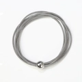 Elastic stainless steel spring bracelet featuring a polished silver metal ball charm - Steel Color