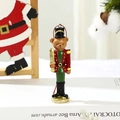 Detail of a resin Christmas bear nutcracker soldier ornament with festive red and green paint - Bear Nutcracker Soldier